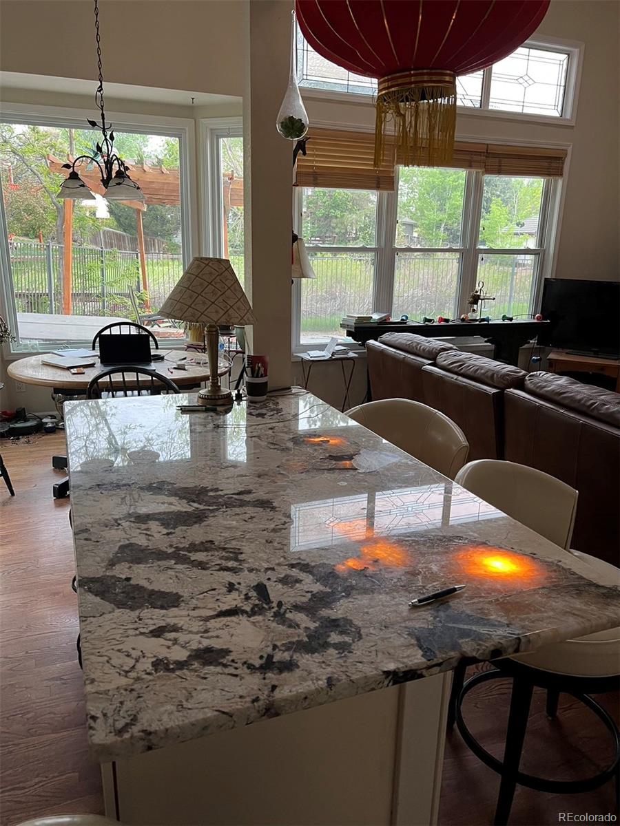 6722 Eagle Place Highlands Ranch, CO 80130 - Photo 26 of 34 a kitchen with kitchen island granite countertop a stove and a sink