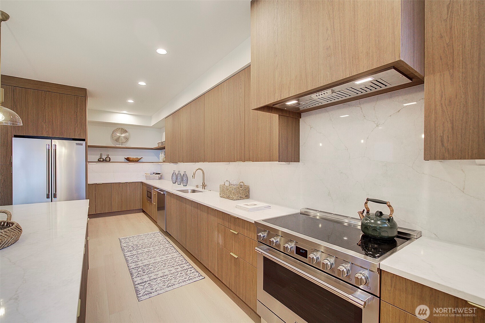 7341 California Avenue Southwest Seattle, WA 98136 - Photo 13 of 38 a kitchen with a sink stainless steel appliances and white cabinets