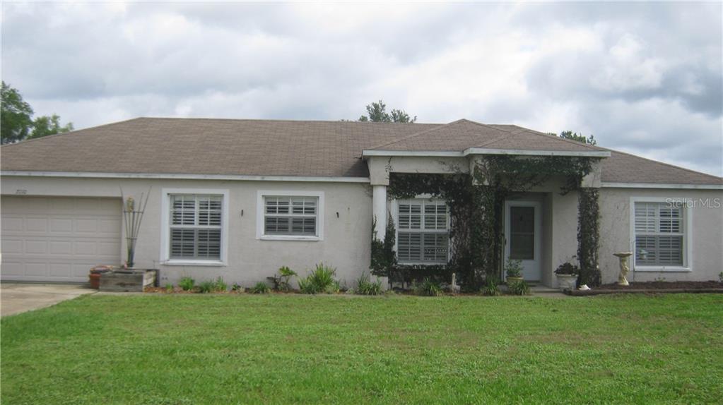 7110 Muck Pond Road Dover, FL 33527 - Photo 1 of 1 front view of a house with a yard
