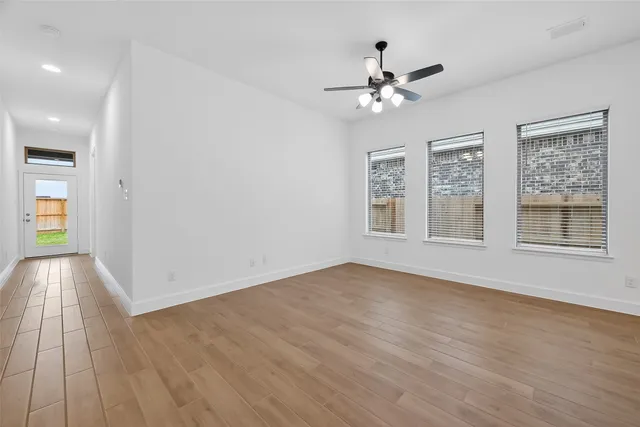 a large kitchen with a refrigerator and a stove top oven