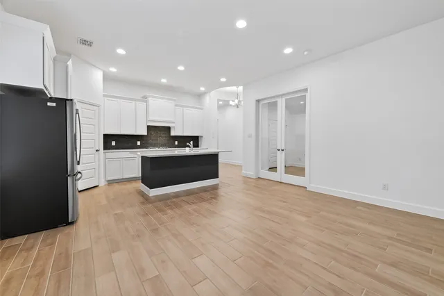 a kitchen with a stove a sink and a refrigerator