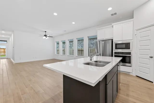 a kitchen with stainless steel appliances granite countertop a sink stove and cabinets
