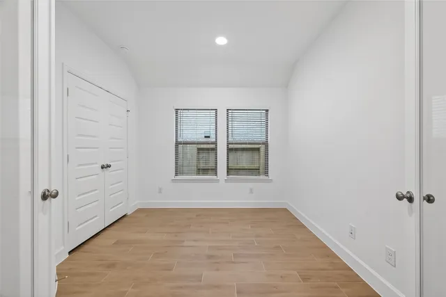 wooden floor in an empty room with a window