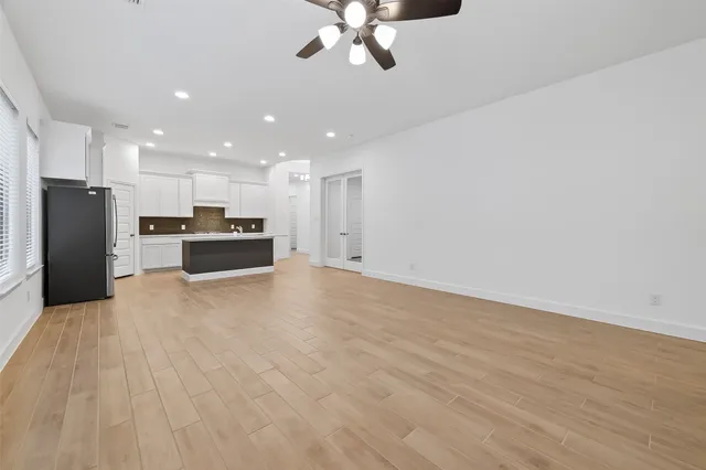 a view of an empty room with wooden floor