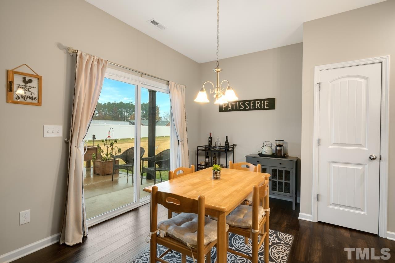 285 Bella Square Smithfield, NC 27577 - Photo 11 of 30 a view of a dining room with furniture window and wooden floor