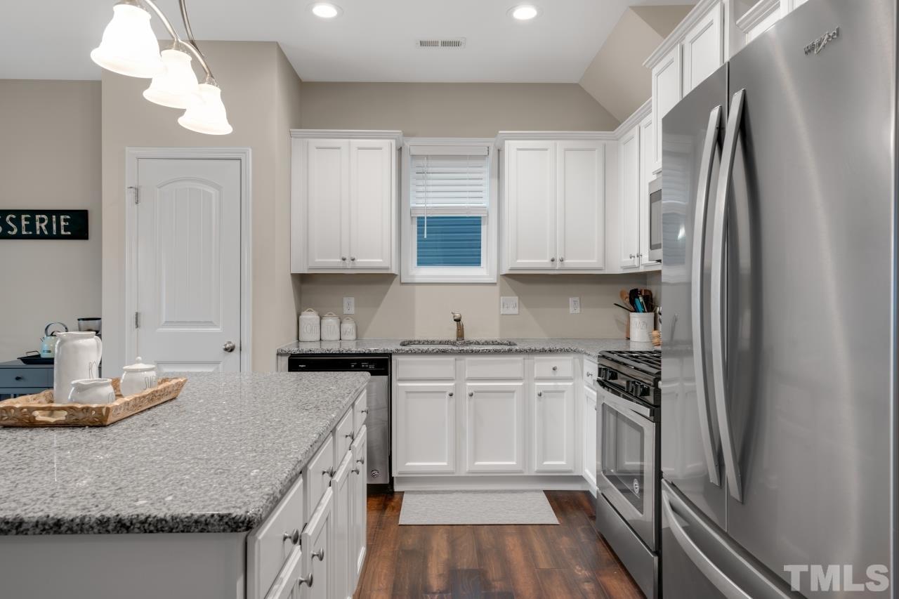 285 Bella Square Smithfield, NC 27577 - Photo 12 of 30 a kitchen with granite countertop a sink stove and refrigerator