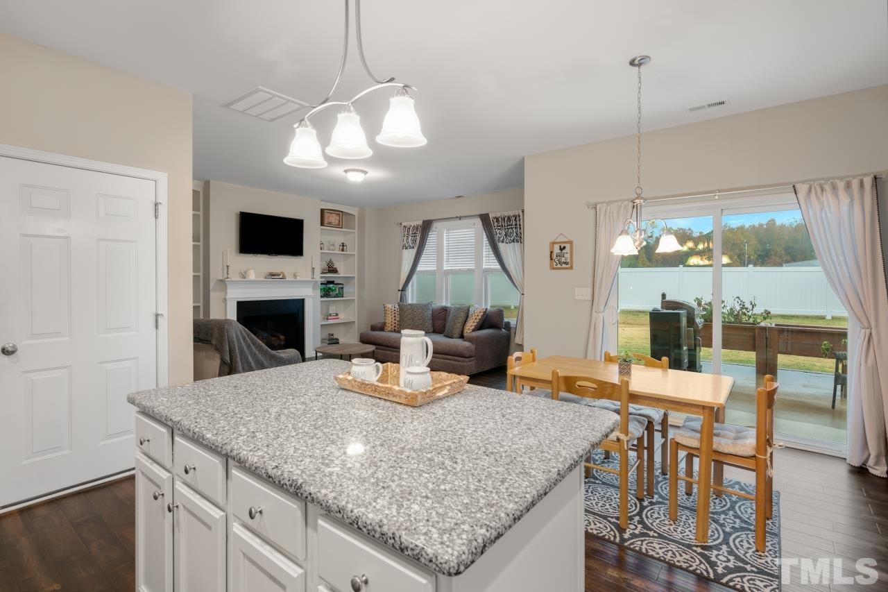 285 Bella Square Smithfield, NC 27577 - Photo 13 of 30 a kitchen with a table chairs and wooden floor