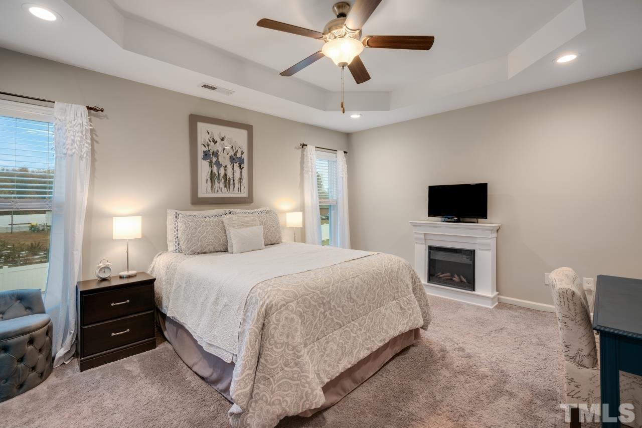 285 Bella Square Smithfield, NC 27577 - Photo 18 of 30 a spacious bedroom with a bed and a flat screen tv