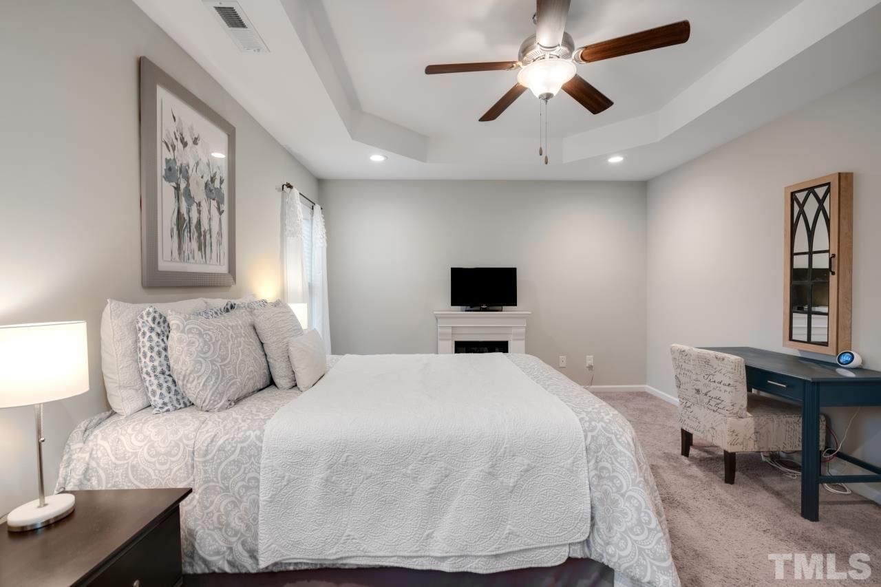 285 Bella Square Smithfield, NC 27577 - Photo 19 of 30 a bedroom with a bed and a table