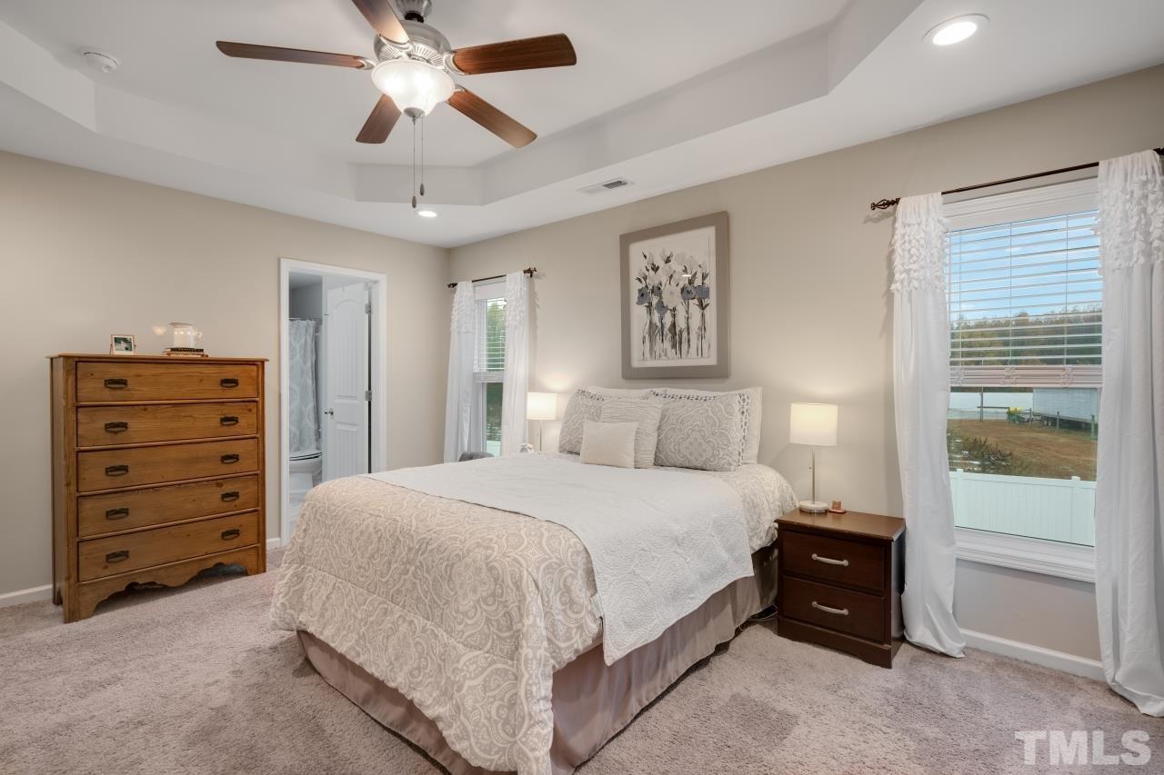 285 Bella Square Smithfield, NC 27577 - Photo 20 of 30 a bedroom with a bed and a cabinets