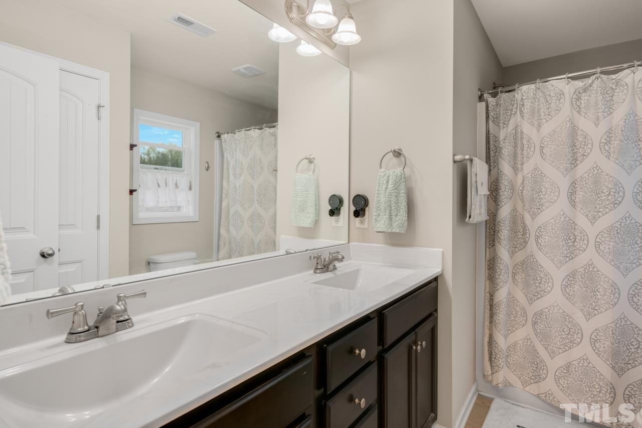 285 Bella Square Smithfield, NC 27577 - Photo 21 of 30 a bathroom with a sink double vanity and a mirror