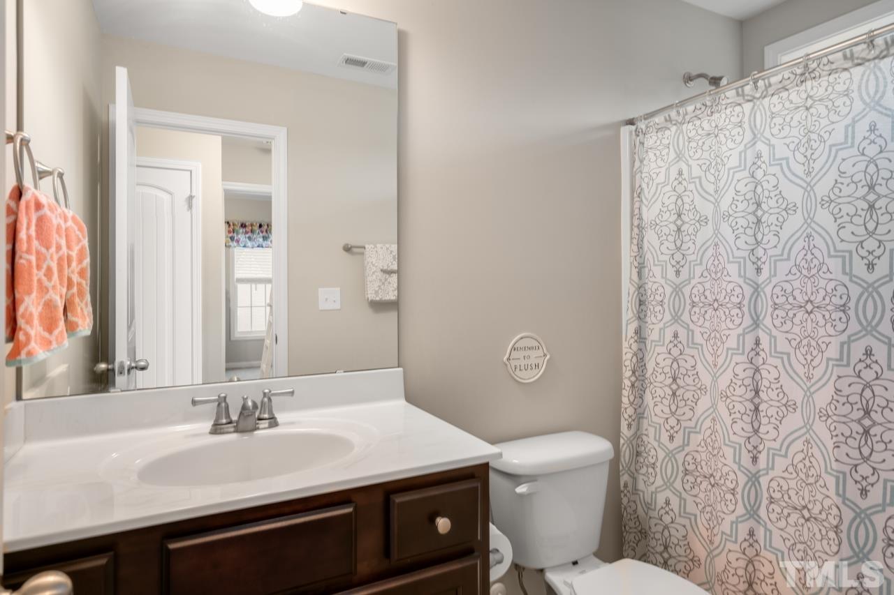 285 Bella Square Smithfield, NC 27577 - Photo 23 of 30 a bathroom with a sink a toilet and shower
