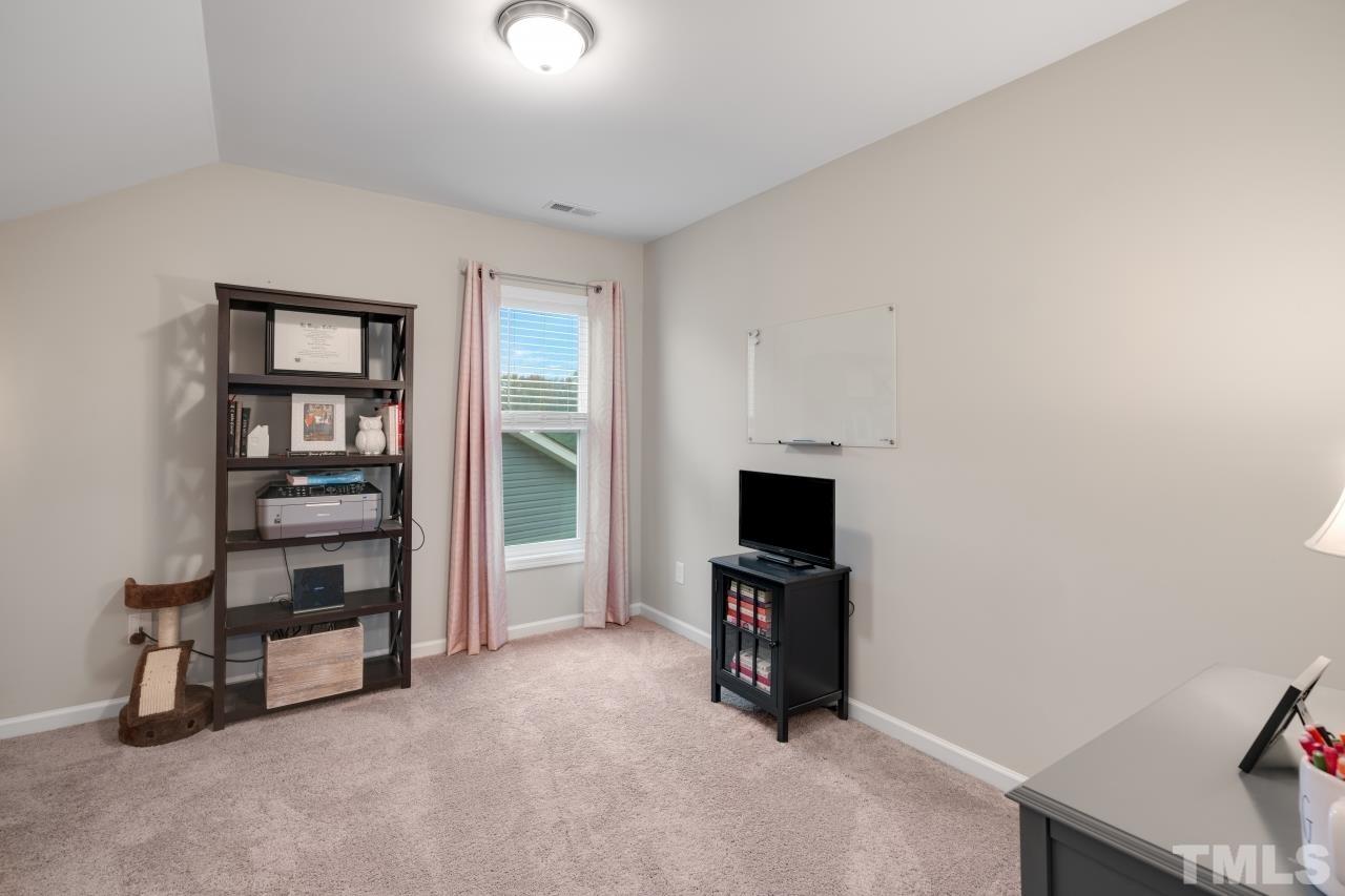285 Bella Square Smithfield, NC 27577 - Photo 24 of 30 a view of an empty room with a fireplace and a window