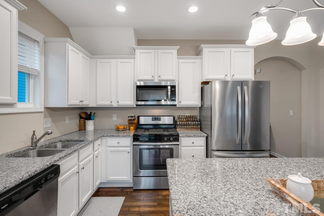 285 Bella Square Smithfield, NC 27577 - Photo 4 of 30 a kitchen with granite countertop a refrigerator oven a sink and dishwasher