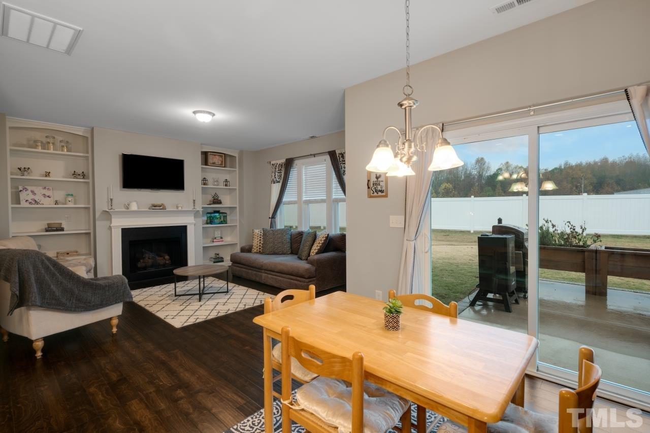 285 Bella Square Smithfield, NC 27577 - Photo 6 of 30 a living room with furniture a flat screen tv and a fireplace