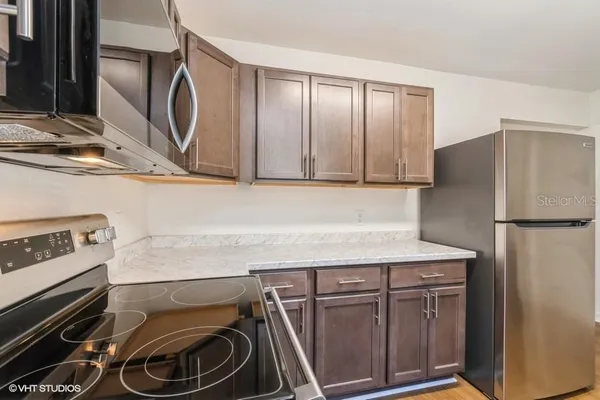 a kitchen with a refrigerator and a sink