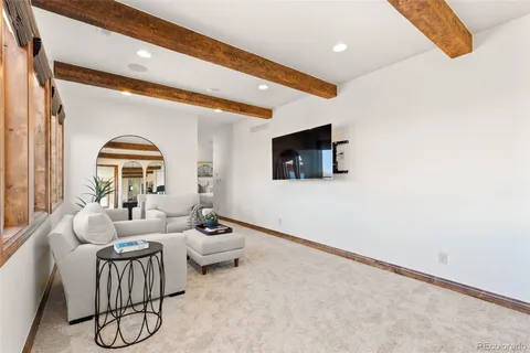 a living room with fireplace furniture and a flat screen tv