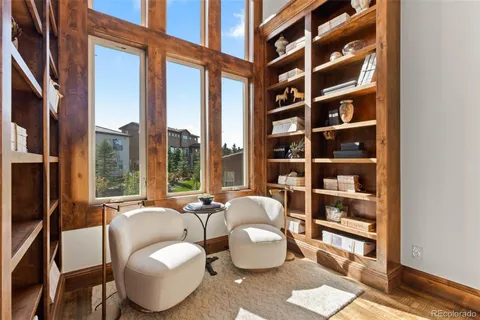 a living room with furniture a rug and a window
