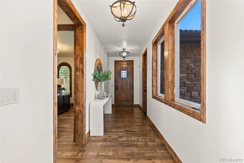 a view of a hallway with windows and couches