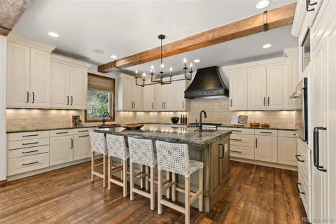 a kitchen with a sink stove and white cabinets