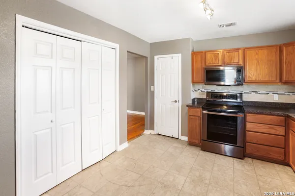 a kitchen with a stove and a microwave