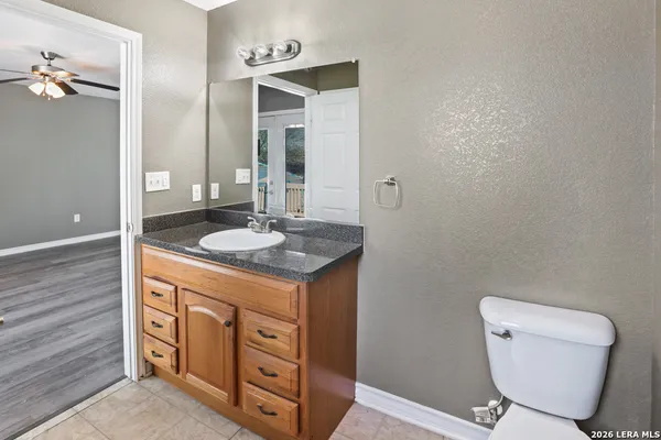 a bathroom with a toilet sink and mirror