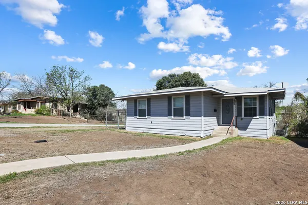 a view of a house with a yard and tree s