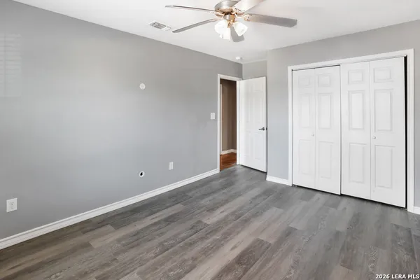 a view of an empty room with wooden floor