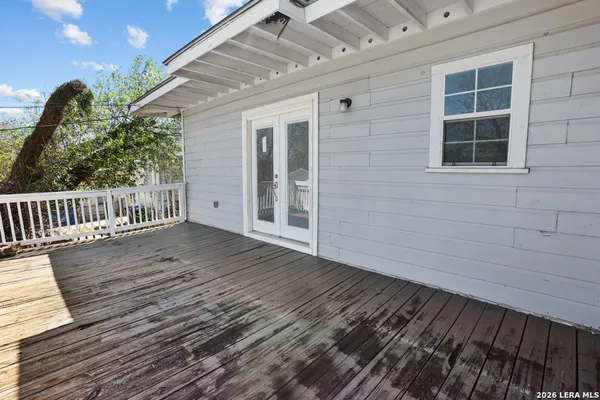 a view of backyard with deck and wooden floor