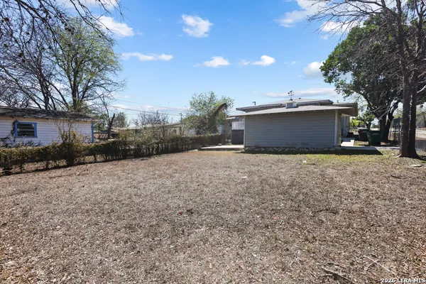 a view of a house with a yard and tree