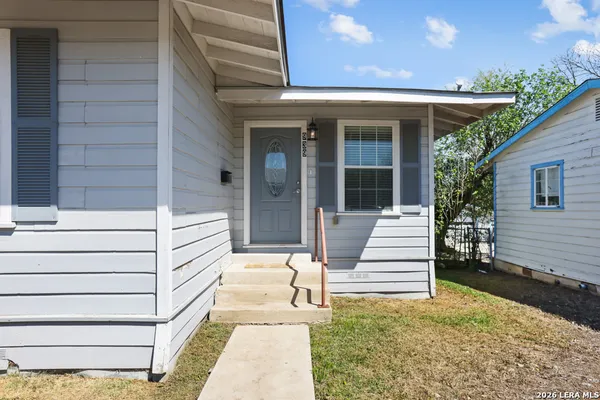 a view of a patio with table and chairs