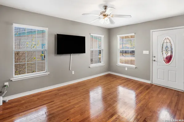 a bedroom with furniture flat screen tv and a window