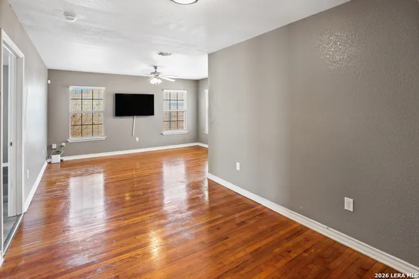 a view of a livingroom with wooden floor and a flat screen tv