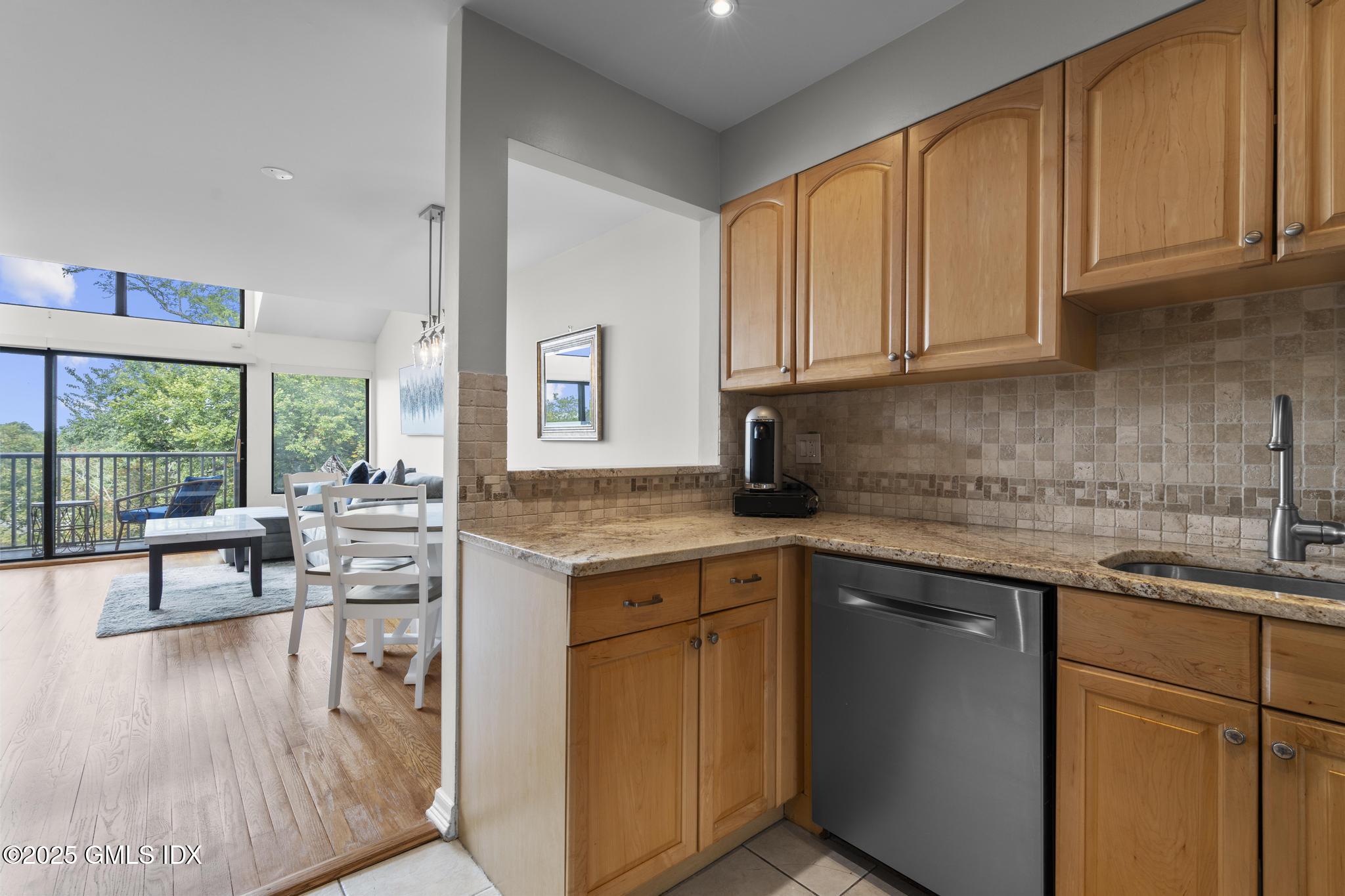 1465 East Putnam Avenue, Unit 421 Riverside, CT 06878 - Photo 13 of 29 a kitchen with stainless steel appliances granite countertop a sink stove and cabinets