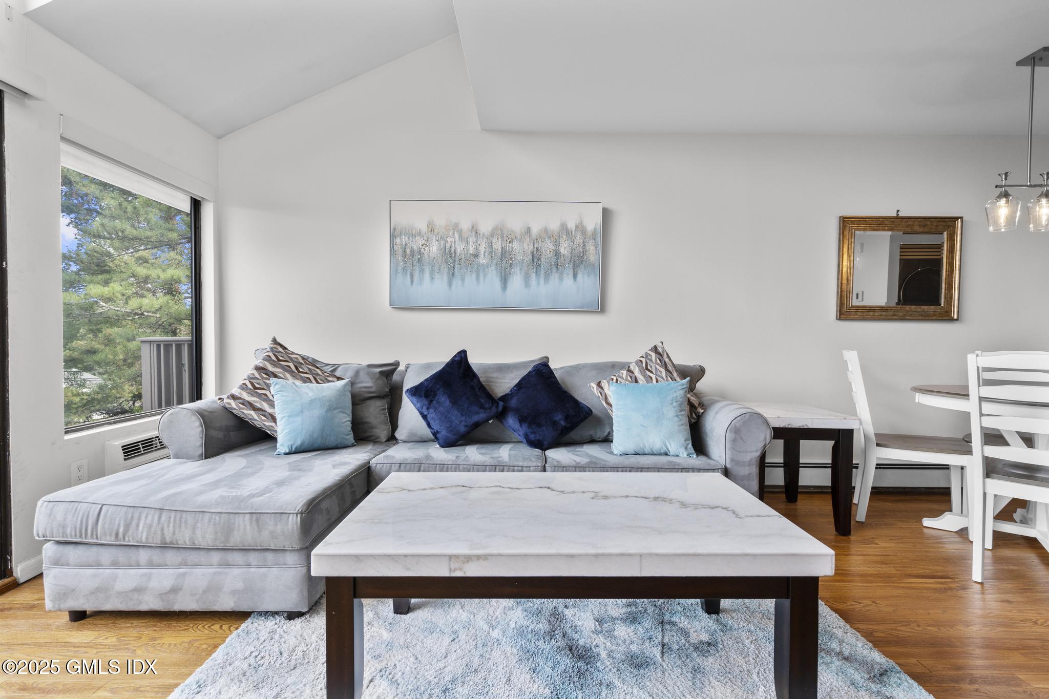 1465 East Putnam Avenue, Unit 421 Riverside, CT 06878 - Photo 14 of 29 a large bedroom with a bed and wooden floor