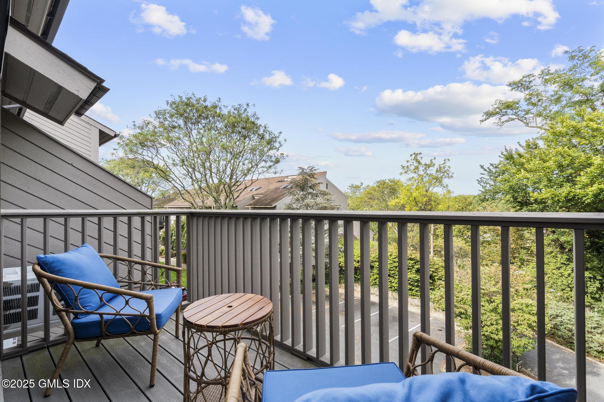 1465 East Putnam Avenue, Unit 421 Riverside, CT 06878 - Photo 15 of 29 a view of a two chairs and table in the balcony