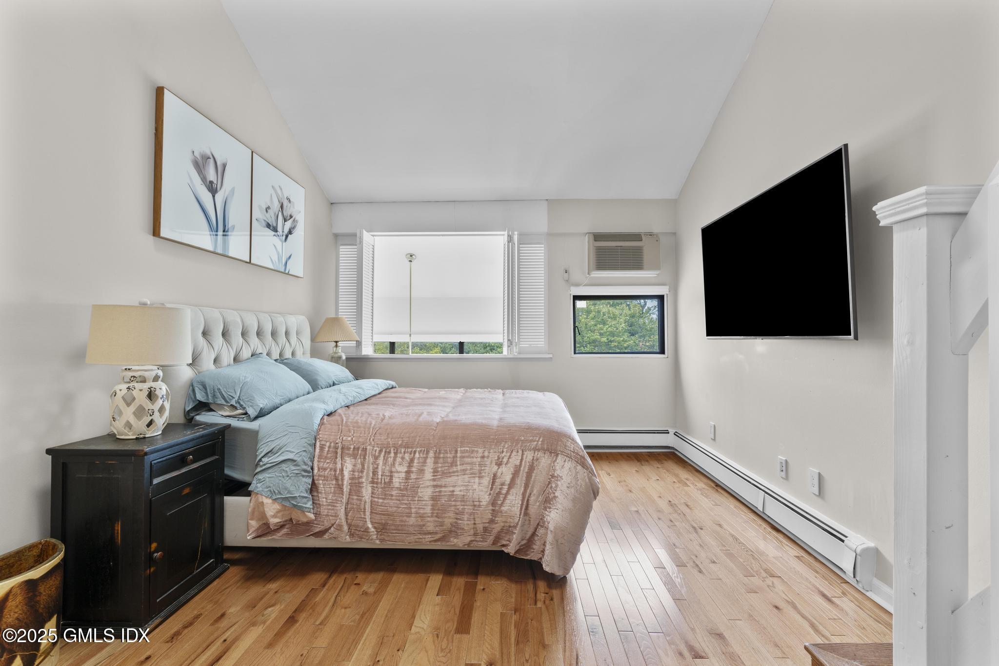 1465 East Putnam Avenue, Unit 421 Riverside, CT 06878 - Photo 17 of 29 a bedroom with a bed and a flat screen tv