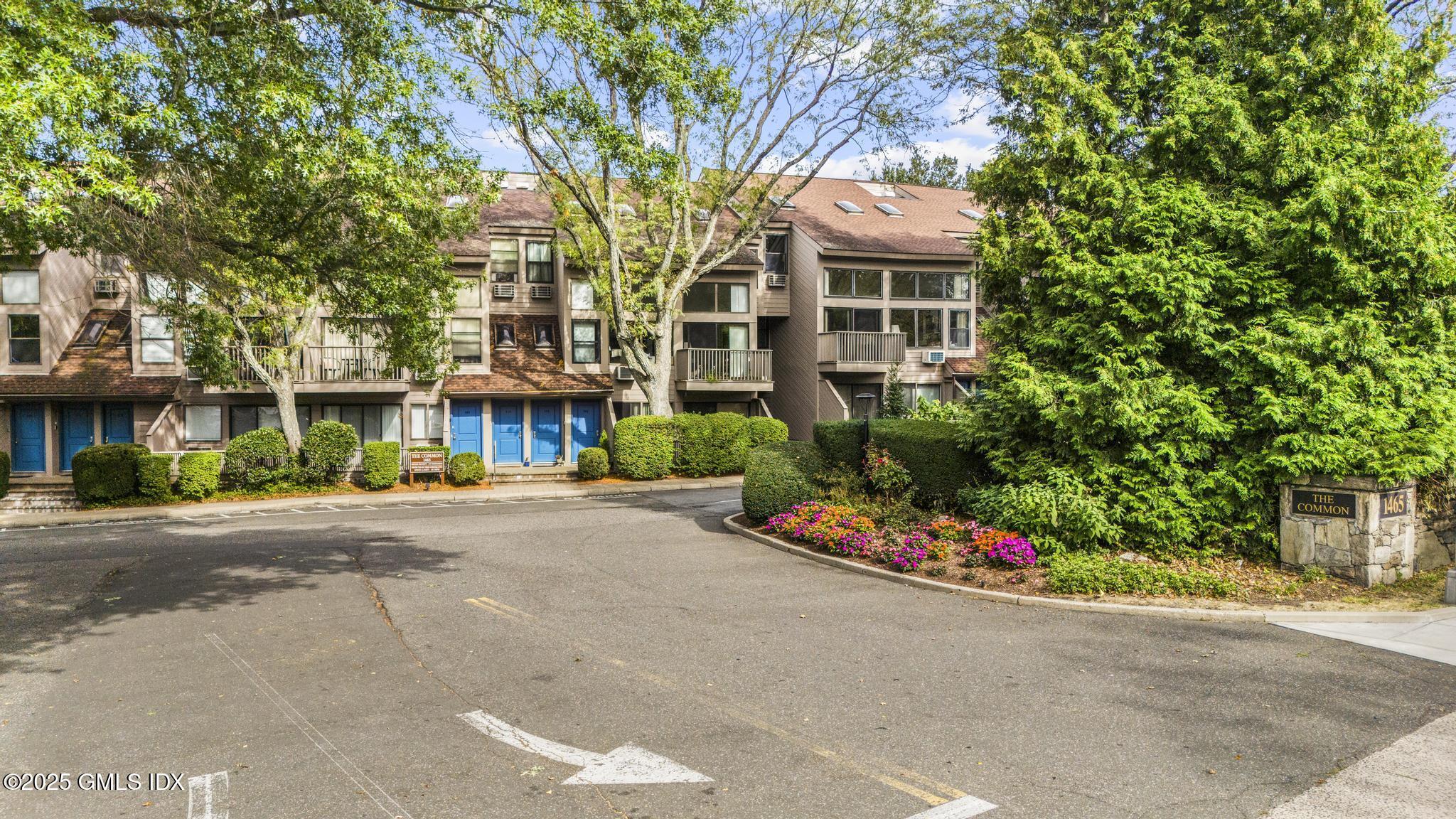 1465 East Putnam Avenue, Unit 421 Riverside, CT 06878 - Photo 24 of 29 a front view of a building with garden