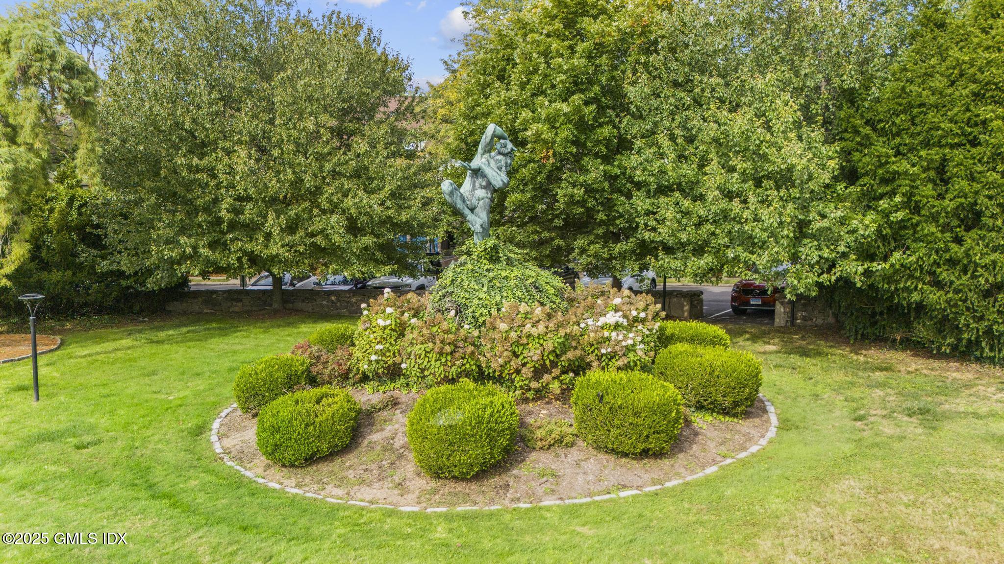 1465 East Putnam Avenue, Unit 421 Riverside, CT 06878 - Photo 25 of 29 a backyard of a house with lots of green space