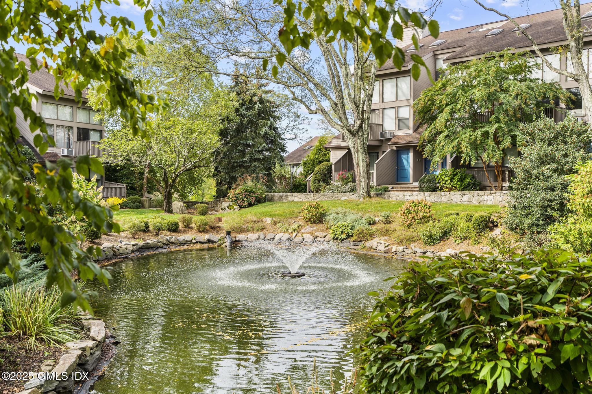 1465 East Putnam Avenue, Unit 421 Riverside, CT 06878 - Photo 27 of 29 a house with river in front of it