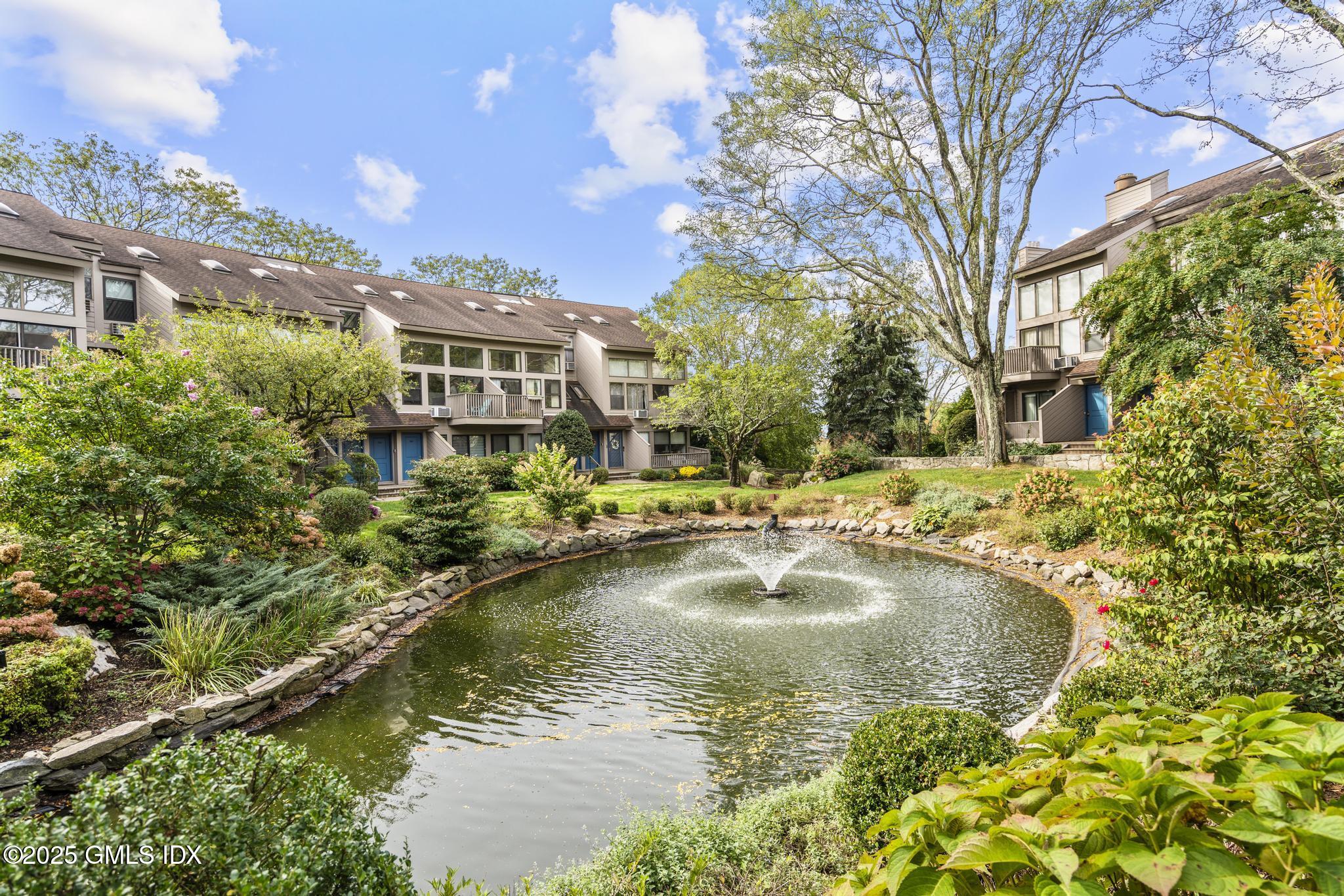 1465 East Putnam Avenue, Unit 421 Riverside, CT 06878 - Photo 28 of 29 a view of a lake with a building in the background