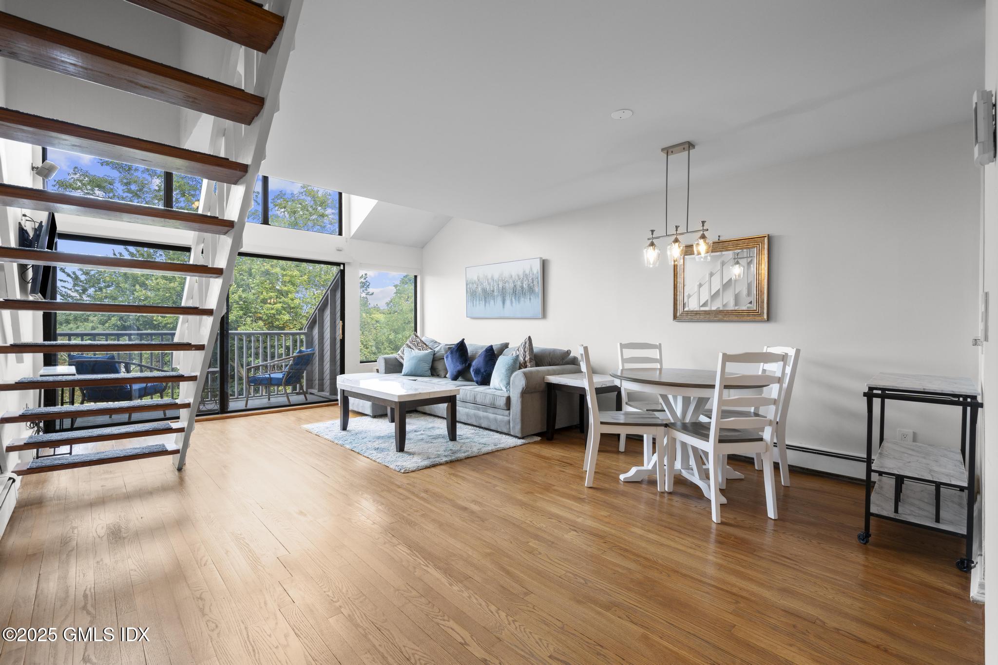 1465 East Putnam Avenue, Unit 421 Riverside, CT 06878 - Photo 3 of 29 a living room with furniture a window and wooden floor