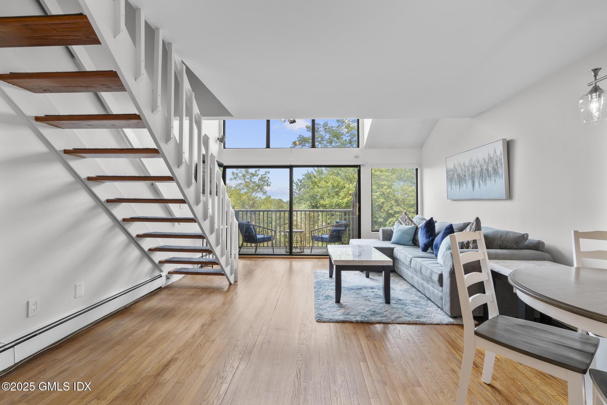 1465 East Putnam Avenue, Unit 421 Riverside, CT 06878 - Photo 4 of 29 a living room with furniture and a large window