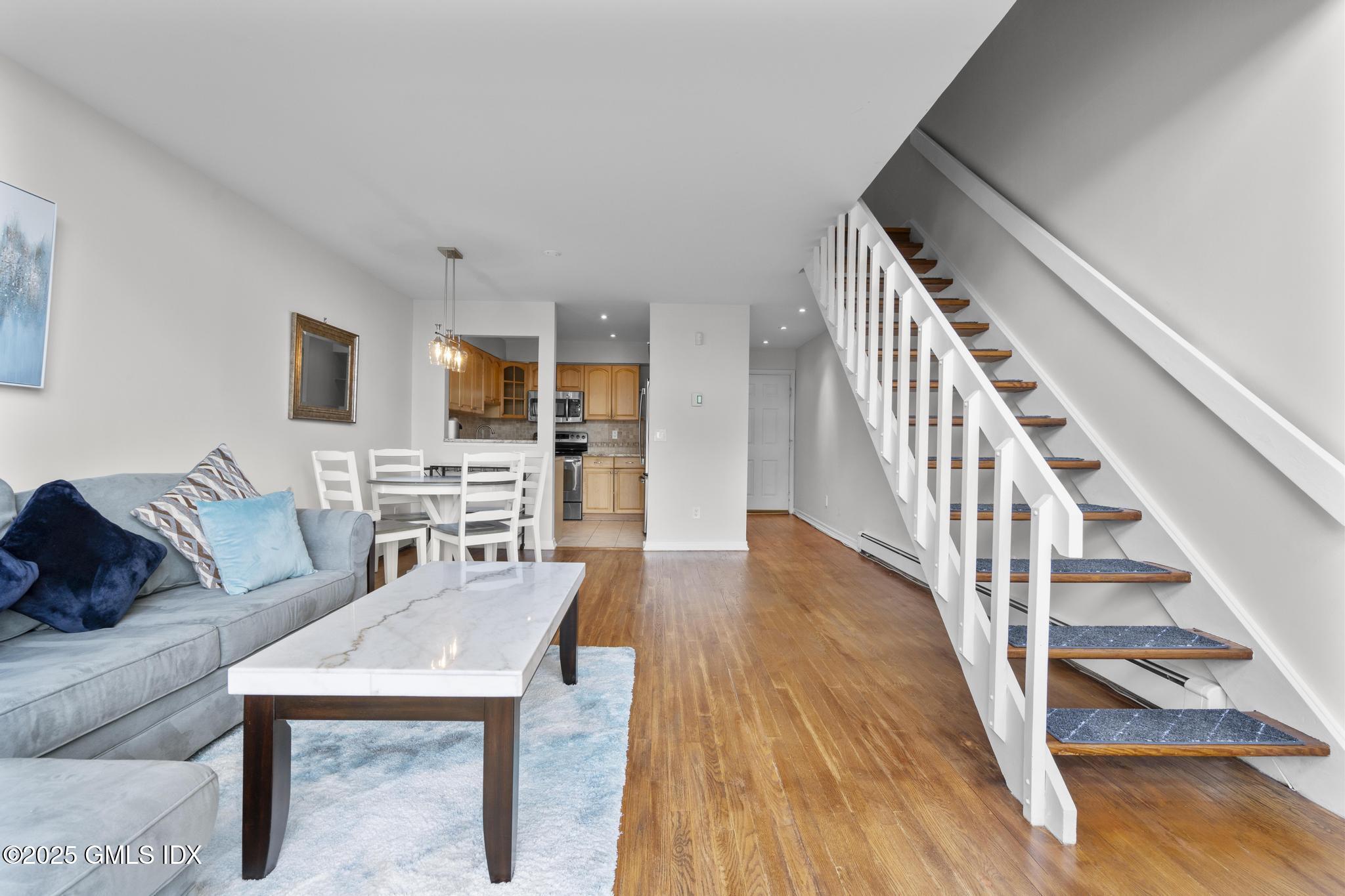 1465 East Putnam Avenue, Unit 421 Riverside, CT 06878 - Photo 6 of 29 a living room with furniture and a wooden floor