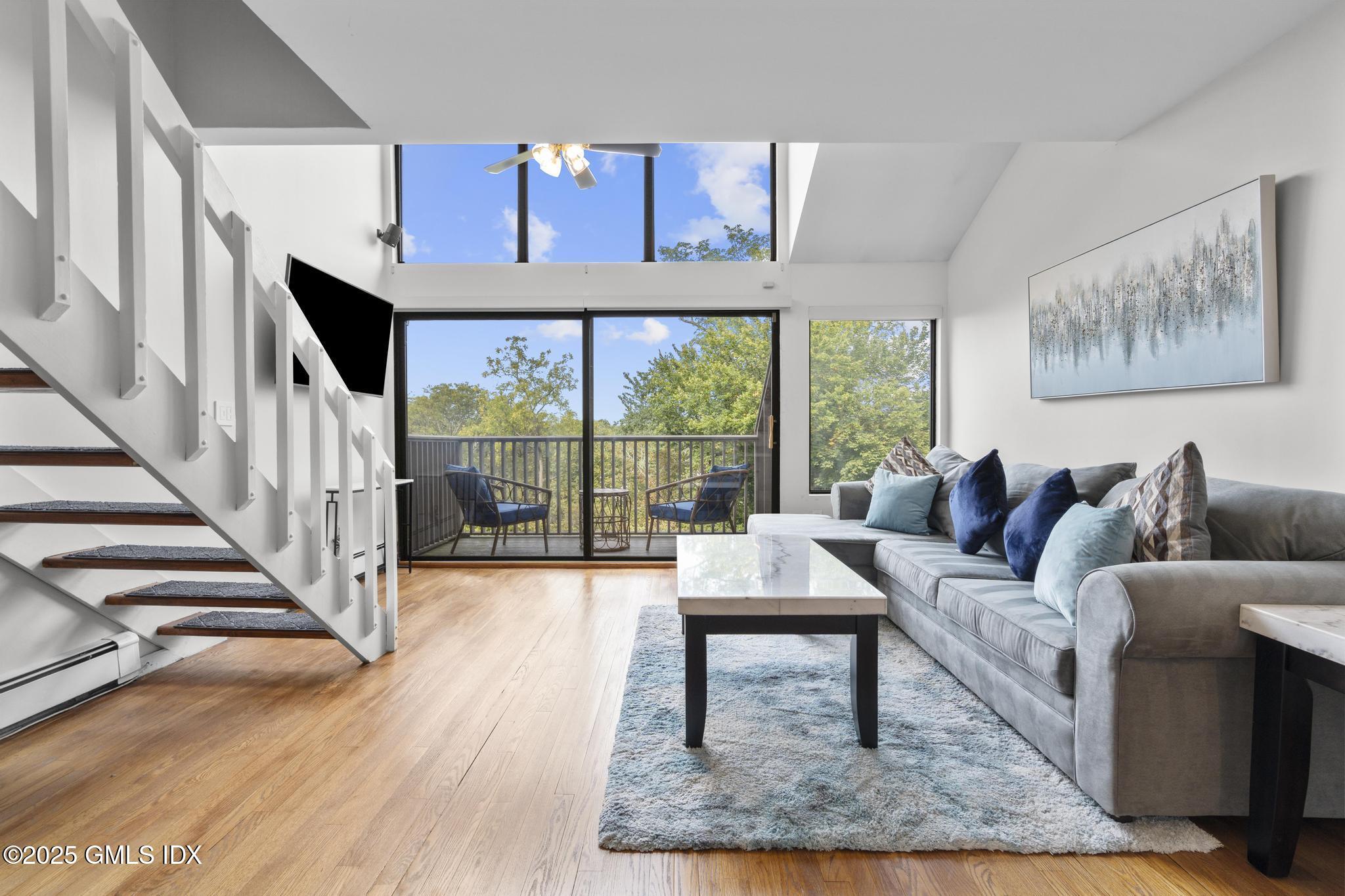 1465 East Putnam Avenue, Unit 421 Riverside, CT 06878 - Photo 7 of 29 a living room with furniture and a large window