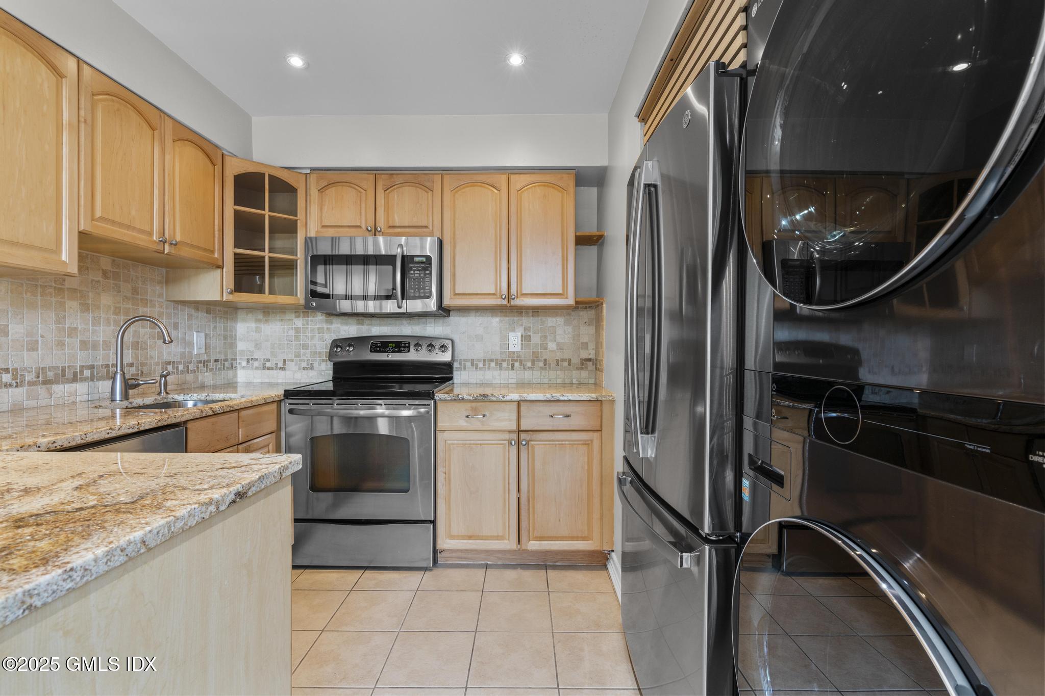 1465 East Putnam Avenue, Unit 421 Riverside, CT 06878 - Photo 8 of 29 a kitchen with a refrigerator and a sink