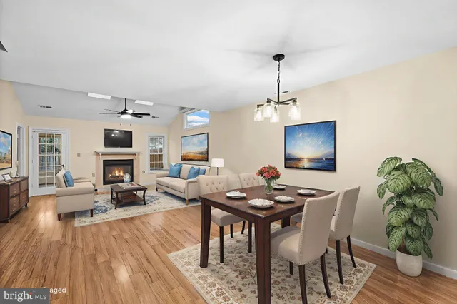 a living room with fireplace furniture and a wooden floor