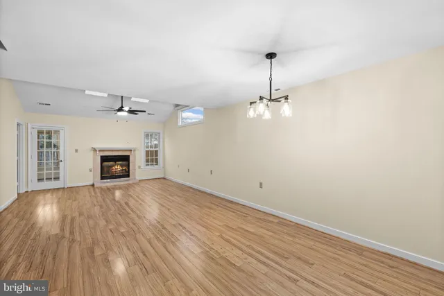 wooden floor in an empty room with a fireplace