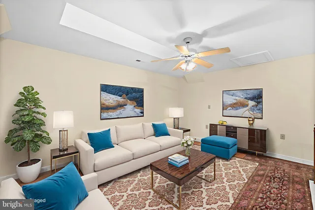 a living room with furniture and a potted plant