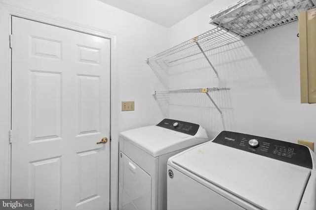 a view of a backyard with wooden fence and large trees